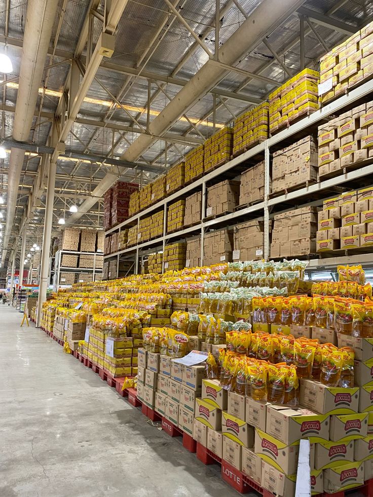 Distribution warehouse with stacked cartons and oil packs
